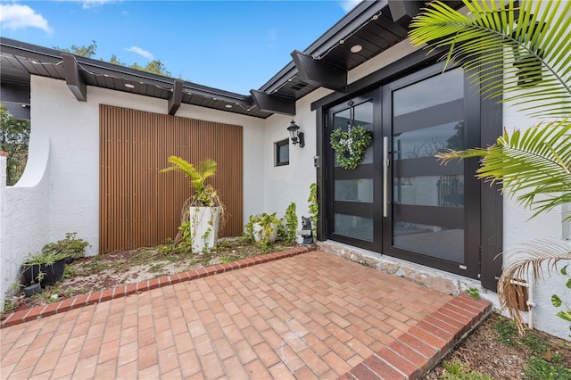 entrance to property featuring french doors and a patio area