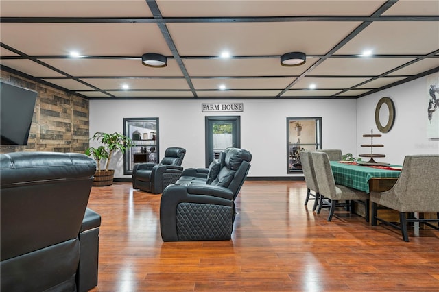 living room featuring coffered ceiling and wood-type flooring