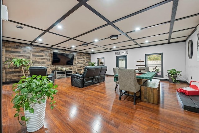 dining area featuring coffered ceiling and wood-type flooring