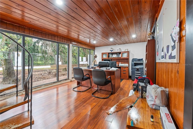 office area with wood walls, wood ceiling, and light wood-type flooring