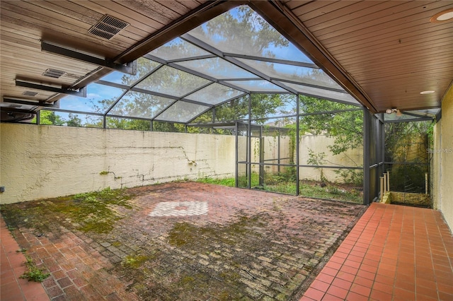 view of patio / terrace featuring glass enclosure