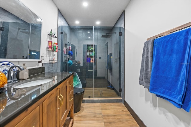 bathroom with an enclosed shower and vanity