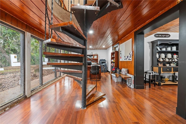 interior space featuring hardwood / wood-style floors, wood ceiling, and wooden walls