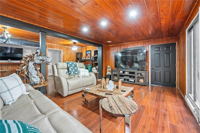 living room featuring wooden ceiling, hardwood / wood-style flooring, and wooden walls