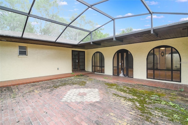 back of property featuring a lanai and a patio