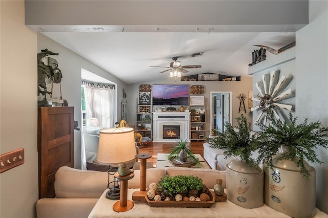 living room with lofted ceiling, ceiling fan, and hardwood / wood-style floors