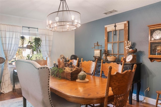 dining space featuring a chandelier and wood-type flooring