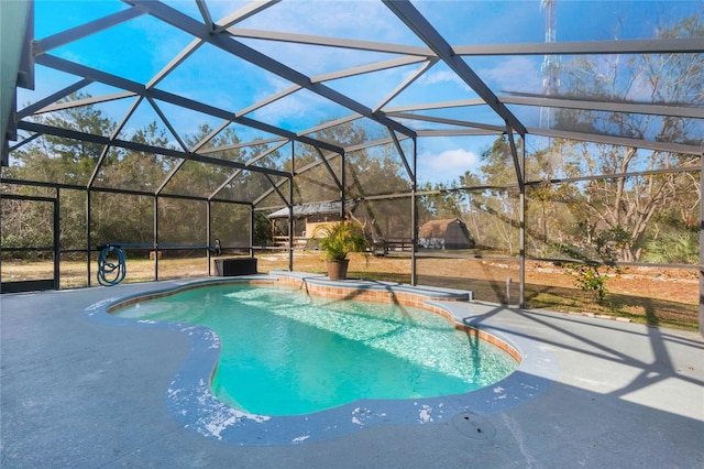 view of pool featuring glass enclosure and a patio