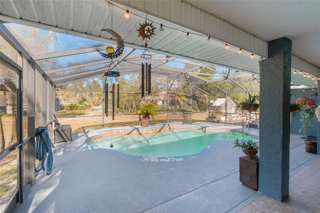 view of swimming pool featuring a lanai and a patio