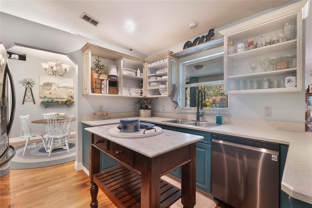 kitchen featuring dishwasher, pendant lighting, sink, light hardwood / wood-style flooring, and blue cabinets