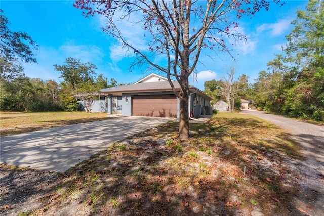 view of front of home with a front lawn and a garage