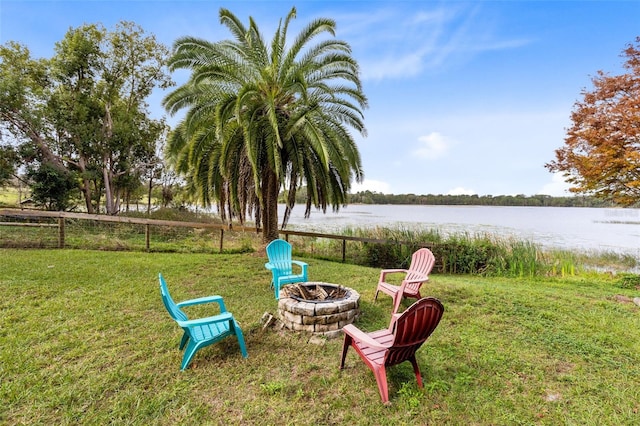 view of yard featuring a fire pit and a water view