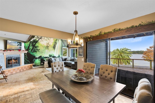 dining room featuring a water view, light parquet flooring, plenty of natural light, and an inviting chandelier