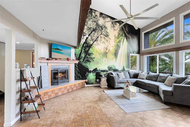 living room featuring ceiling fan, a towering ceiling, and light parquet flooring