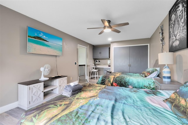 bedroom featuring ceiling fan, a closet, and light hardwood / wood-style flooring