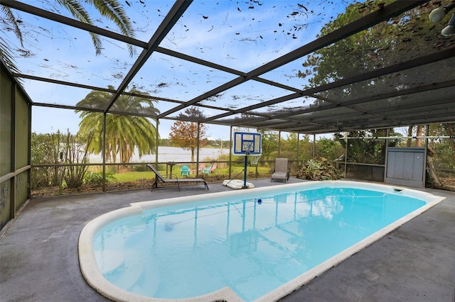 view of swimming pool with a lanai and a patio area