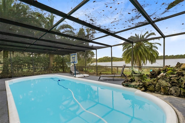 view of swimming pool with a lanai and a water view