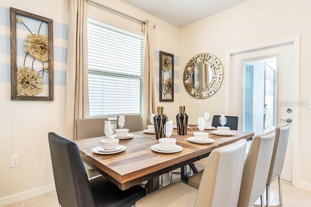 dining area featuring light tile patterned flooring and plenty of natural light