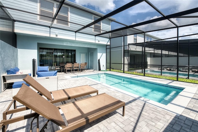 view of pool featuring a lanai and a patio