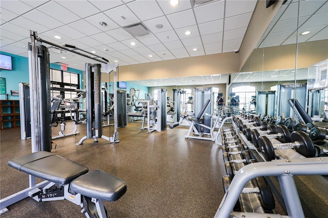 exercise room with a paneled ceiling