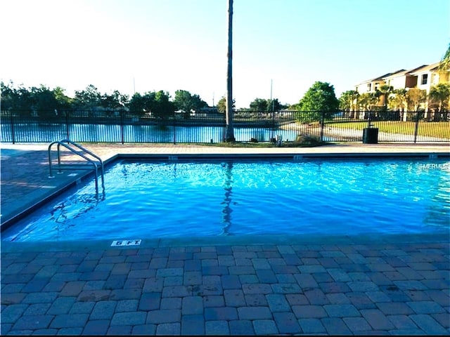 view of pool with a water view