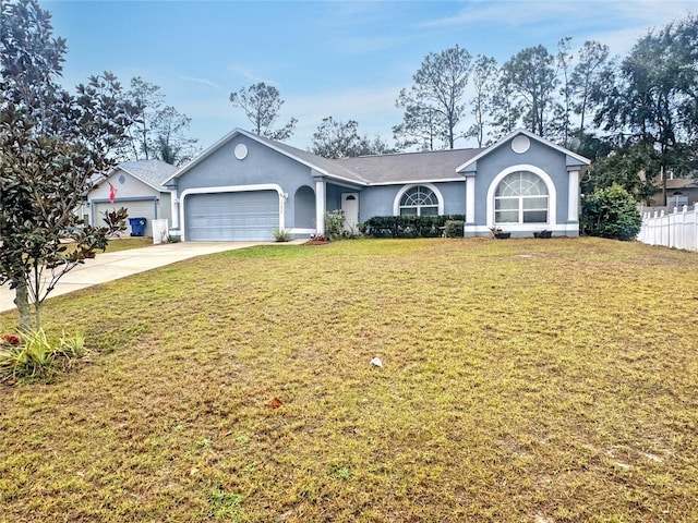 ranch-style house featuring a garage and a front lawn