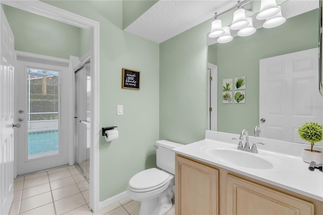 bathroom with toilet, vanity, and tile patterned flooring