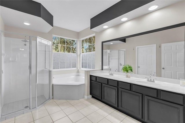 bathroom featuring tile patterned flooring, vanity, and shower with separate bathtub