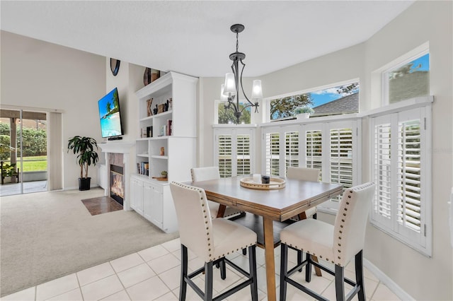 dining area featuring light colored carpet and a notable chandelier