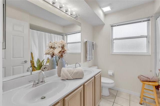 bathroom featuring tile patterned floors, toilet, and vanity