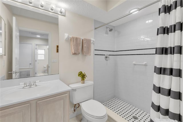 bathroom featuring a shower with curtain, toilet, and vanity