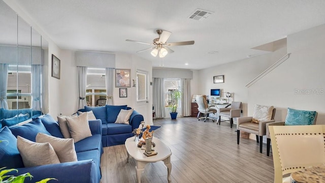 living room with ceiling fan and light wood-type flooring