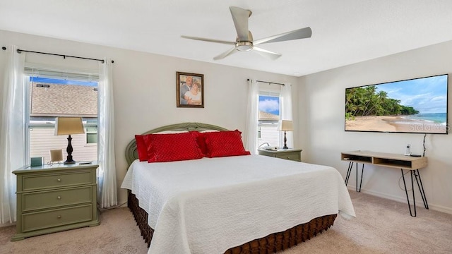 bedroom featuring light colored carpet and ceiling fan