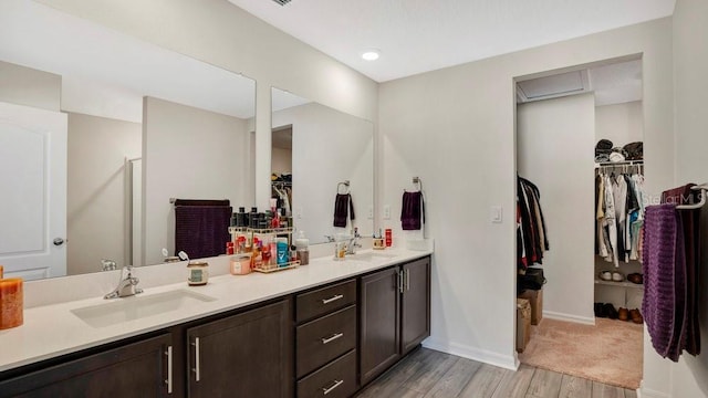 bathroom with hardwood / wood-style flooring, vanity, and an enclosed shower