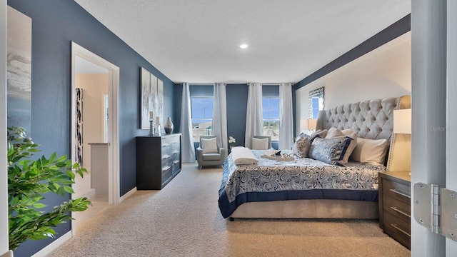 carpeted bedroom featuring a textured ceiling