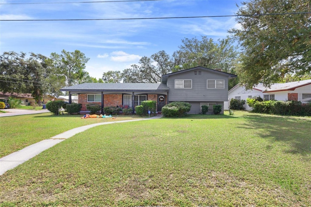 split level home featuring a front lawn