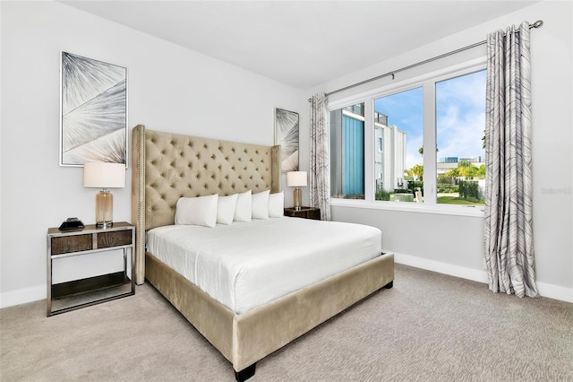 bedroom featuring light colored carpet