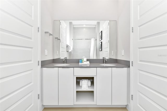 bathroom with walk in shower and vanity