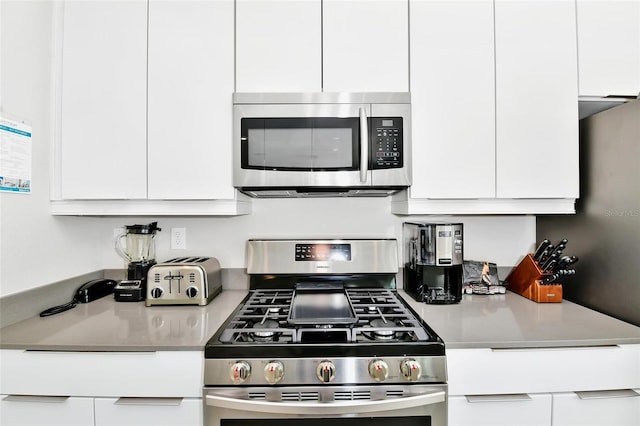 kitchen with stainless steel appliances and white cabinets