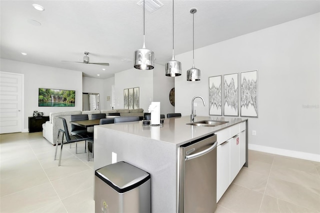 kitchen featuring decorative light fixtures, sink, white cabinets, a kitchen island with sink, and stainless steel dishwasher