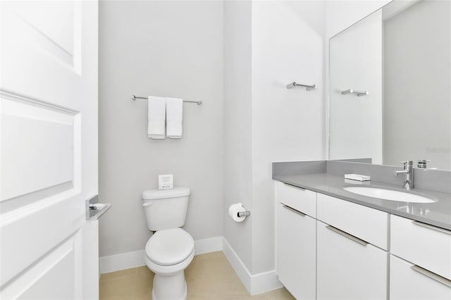 bathroom featuring vanity, tile patterned flooring, and toilet