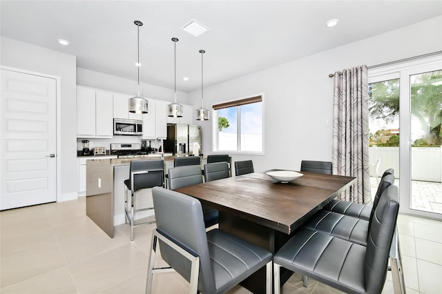 dining area featuring light tile patterned floors and a healthy amount of sunlight