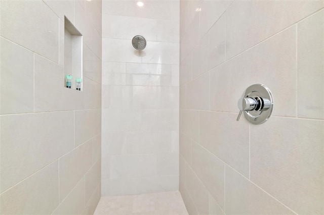 bathroom with a tile shower