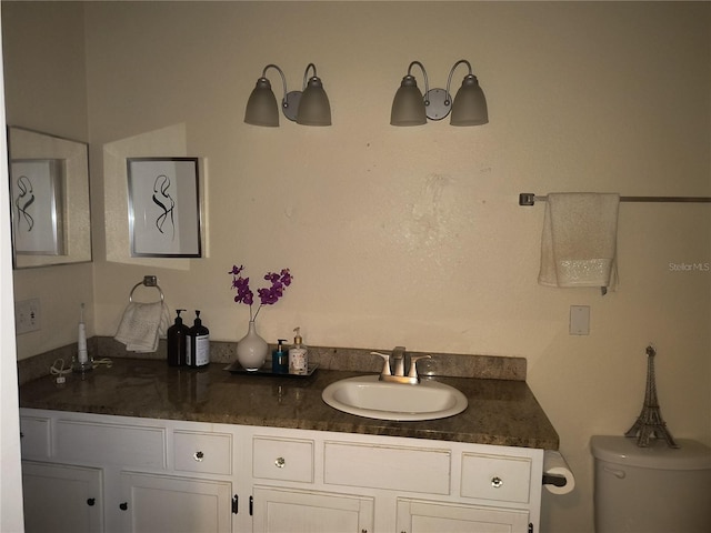 bathroom with toilet and vanity