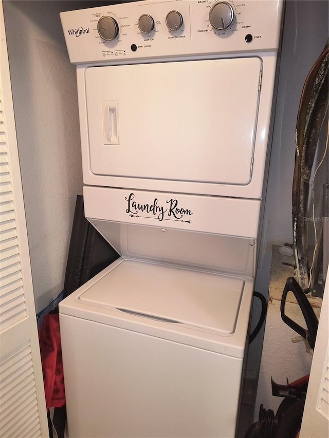 clothes washing area with stacked washer and clothes dryer