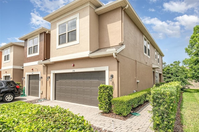 townhome / multi-family property featuring a garage