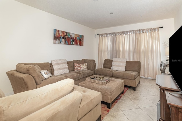 living room with a textured ceiling and light tile patterned flooring