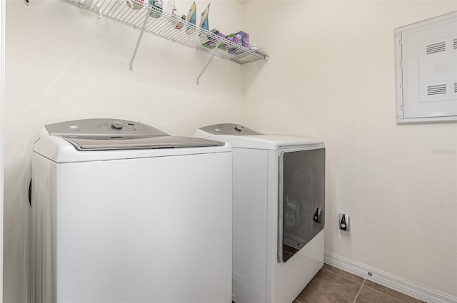 laundry room with separate washer and dryer, tile patterned floors, and electric panel