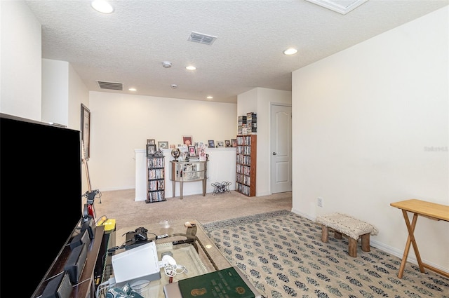 interior space featuring a textured ceiling and carpet