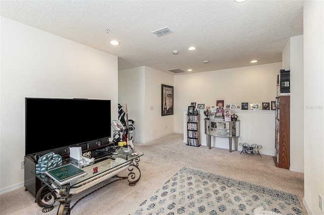 carpeted living room with a textured ceiling